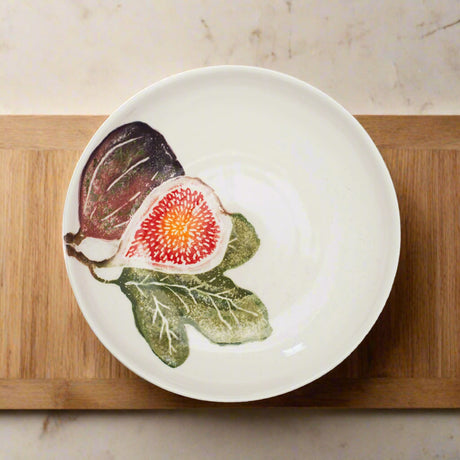 White ceramic plate with fig illustrations on a white background