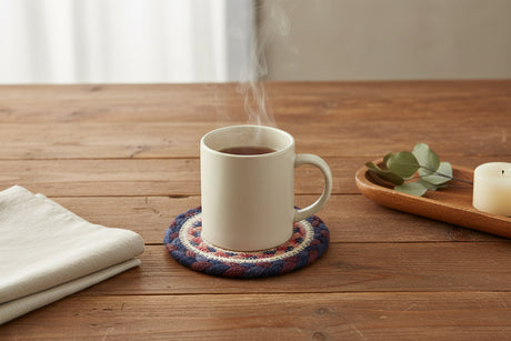 Round woven coaster  with concentric circle pattern on a white background