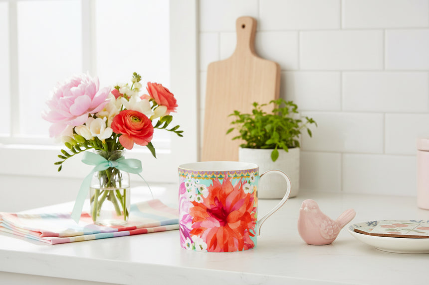 Colorful mug with floral design on a white background