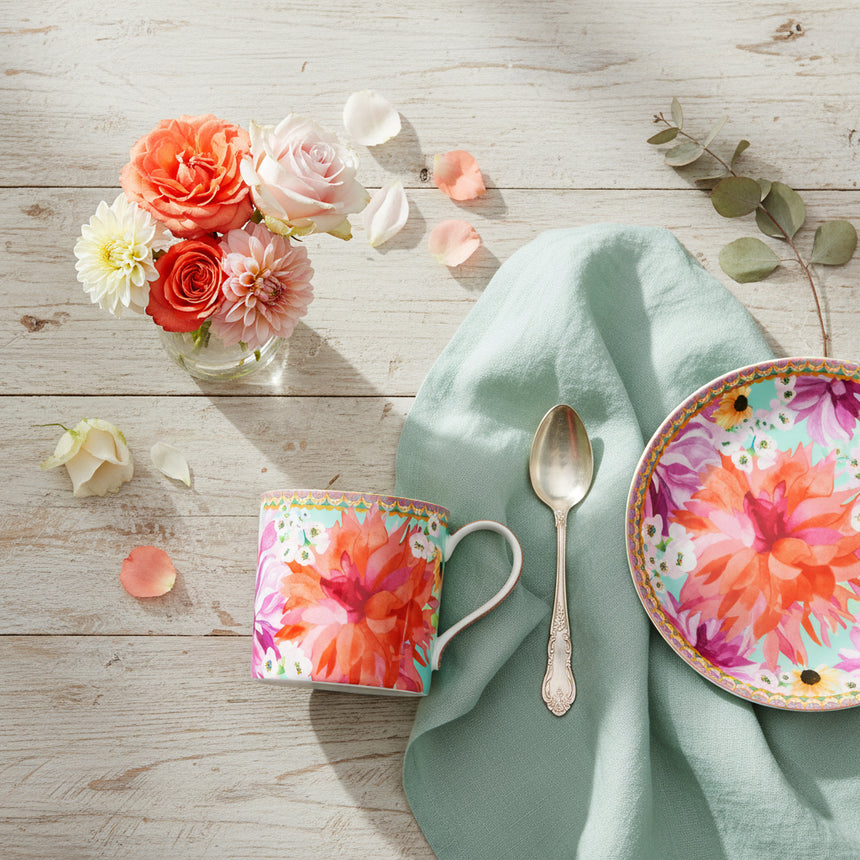 Colorful mug with floral design on a white background