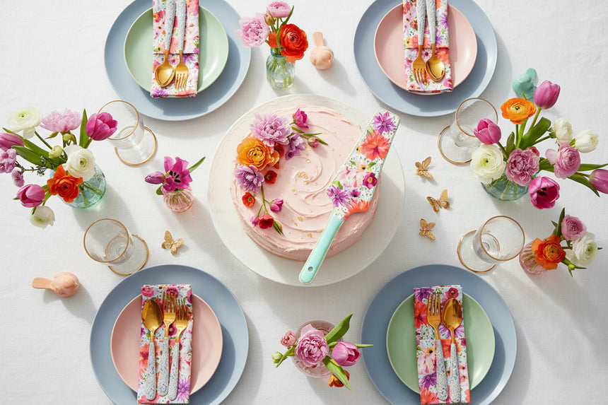 Floral-patterned cake server with a light blue handle on a white background