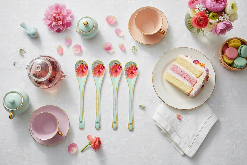 Four decorative spoons with floral designs on a white background