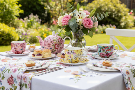 Set of colorful floral teacups and saucers on a white background