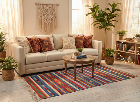 Colorful striped rug with tassels on a light wooden floor