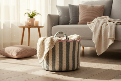 Striped fabric basket with pink trim on a white background