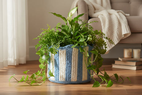 Knitted basket with blue and white striped pattern on a white background
