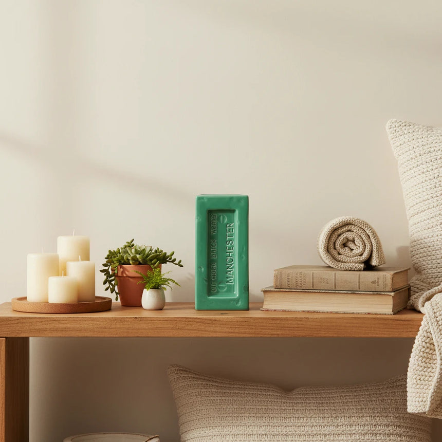 Green rectangular vase with 'Outwood Brick Works Manchester' branding on a white background