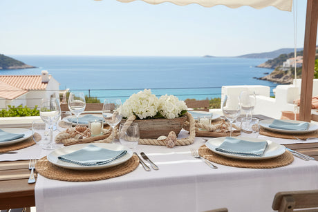 Folded light blue napkin with white trim on a white background