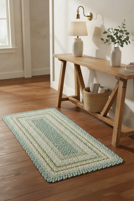 Rectangular braided rug with a multicolor pattern on a white background