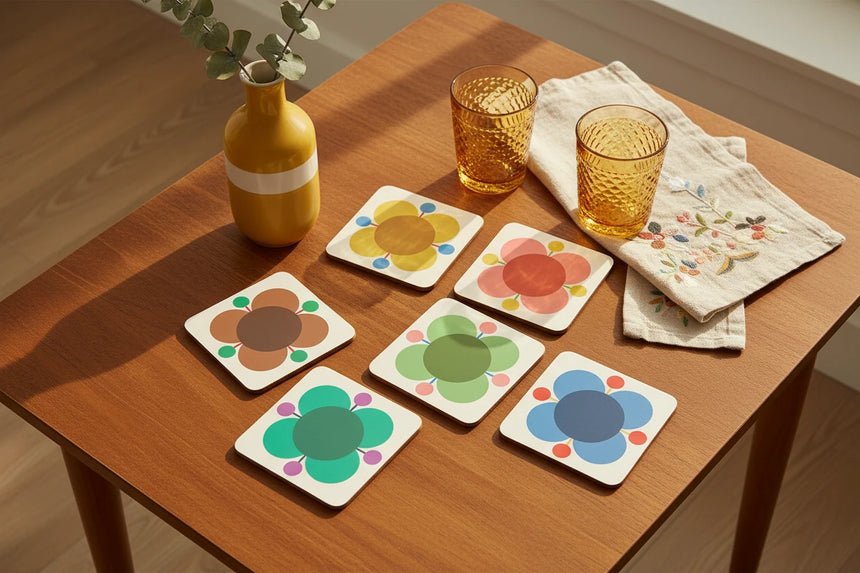 Set of six colorful flower-shaped coasters on a beige background