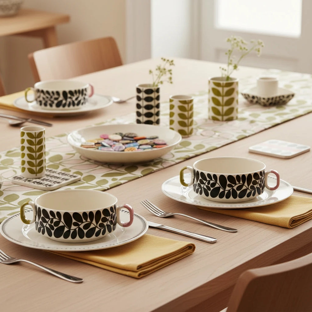 Two ceramic bowls with black leaf pattern on a beige background
