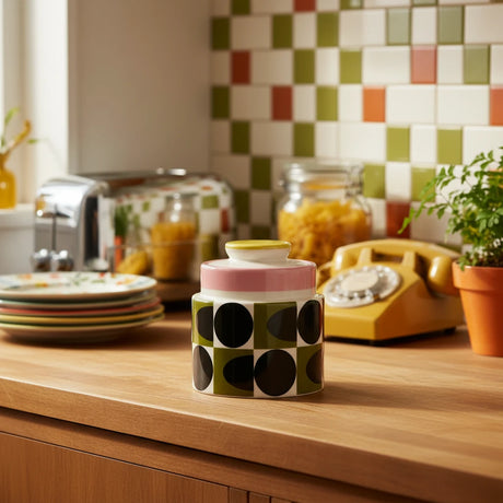 Decorative jar with black dot pattern on a beige background