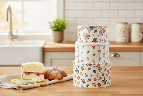 Set of three floral-patterned storage boxes on a white background