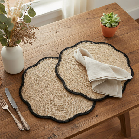 Two round woven placemats with black edges on a white background