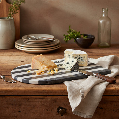 Rectangular cutting board with black and white stripes on a white background