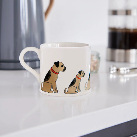 White mug with dog illustrations on a kitchen counter
