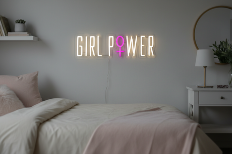 Neon sign with 'GIRL POWER' and a pink gender symbol on a black background