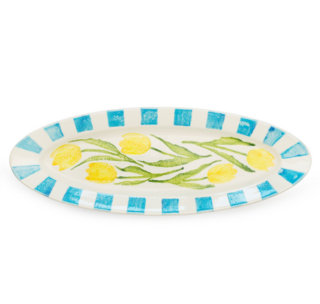 Decorative plate with yellow tulips and blue stripes on a white background