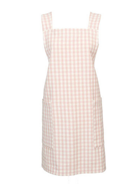 A pink gingham crossback apron with two pockets