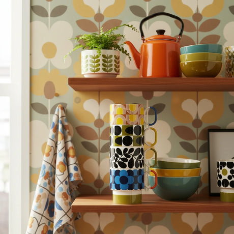 Stack of colorful patterned mugs on a beige background