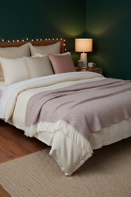 Close-up of a textured fabric with fringes, featuring a neutral color palette.