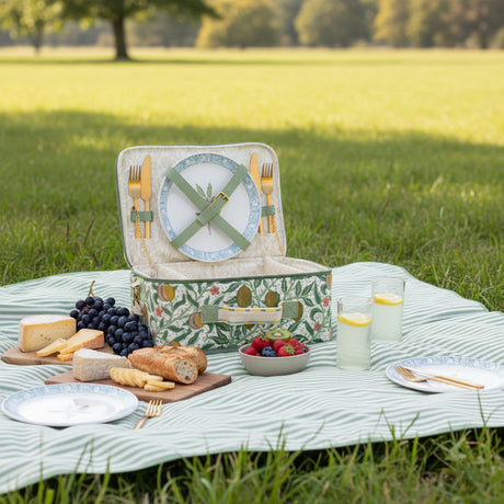 Picnic basket with cutlery and plate set on a white background