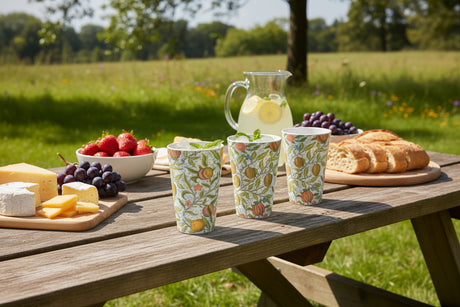 Four Melamine cups with a floral and fruit pattern on a white background