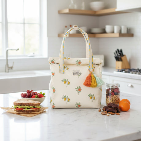 White tote bag with fruit pattern and tassels on a white background