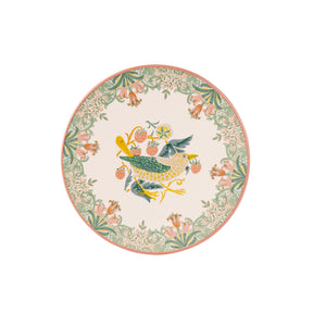 A round decorative trivet featuring a central bird motif in green, yellow, and blue, surrounded by a floral border in soft pink, green, and cream on a white background.