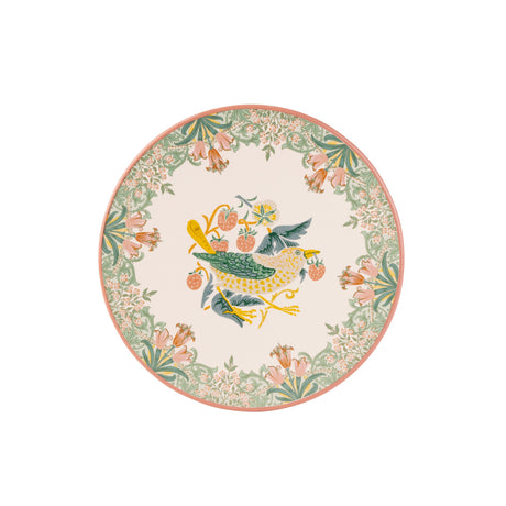 A round decorative trivet featuring a central bird motif in green, yellow, and blue, surrounded by a floral border in soft pink, green, and cream on a white background.
