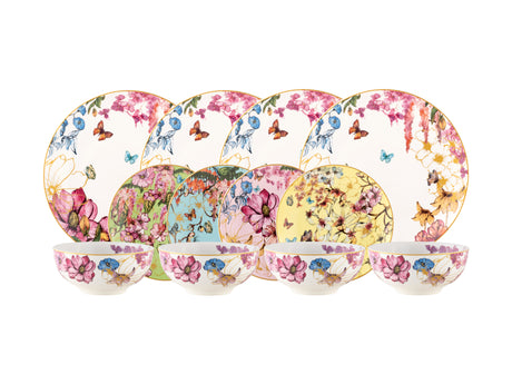 Set of floral and butterfly-patterned plates and bowls on a white background