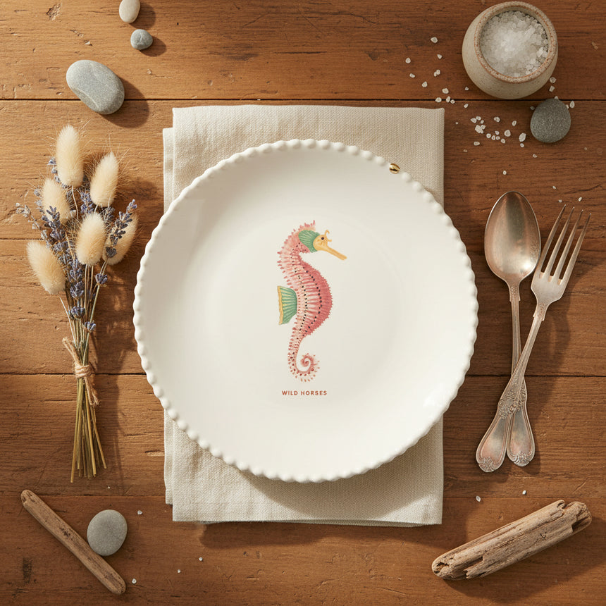 Round cushion with a seahorse design on a white background