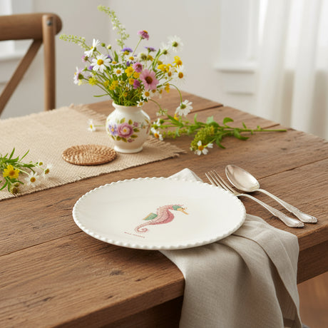 Round white plate with a colorful seahorse design on a white background