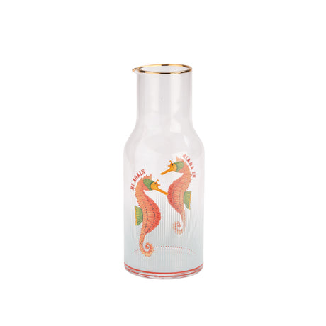 glass carafe with seahorse design on a white background