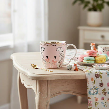 Pink mug with decorative patterns on a white background
