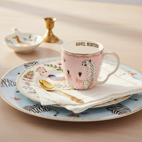 Pink mug with 'Soul Sister' text and animal design on a white background