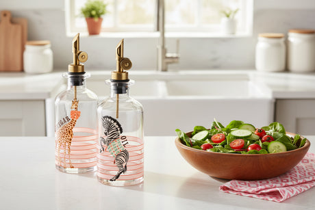 Two glass bottles with animal illustrations and gold nozzles on a white background