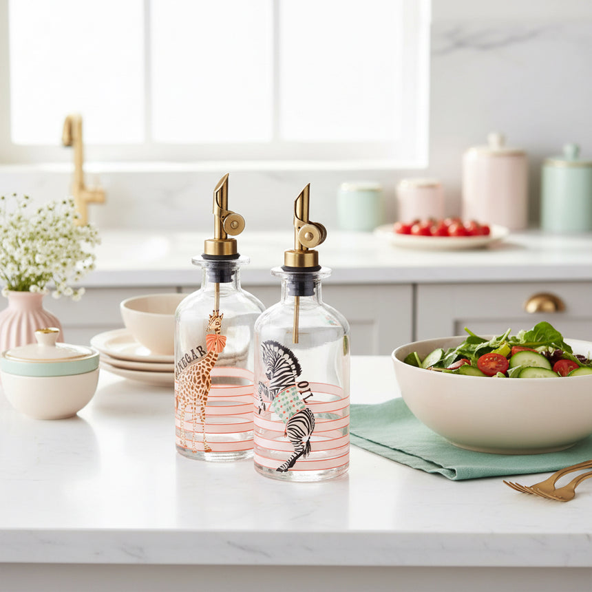 Two glass bottles with animal illustrations and gold nozzles on a white background