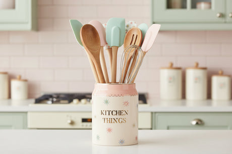 Decorative canister with 'Kitchen Things' text on a white background