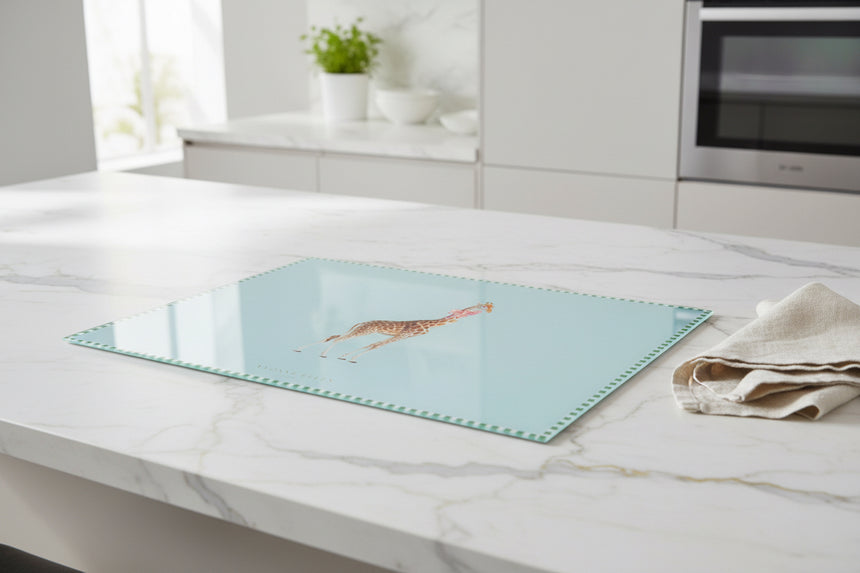 glass worktop saver with a giraffe design on a light blue background