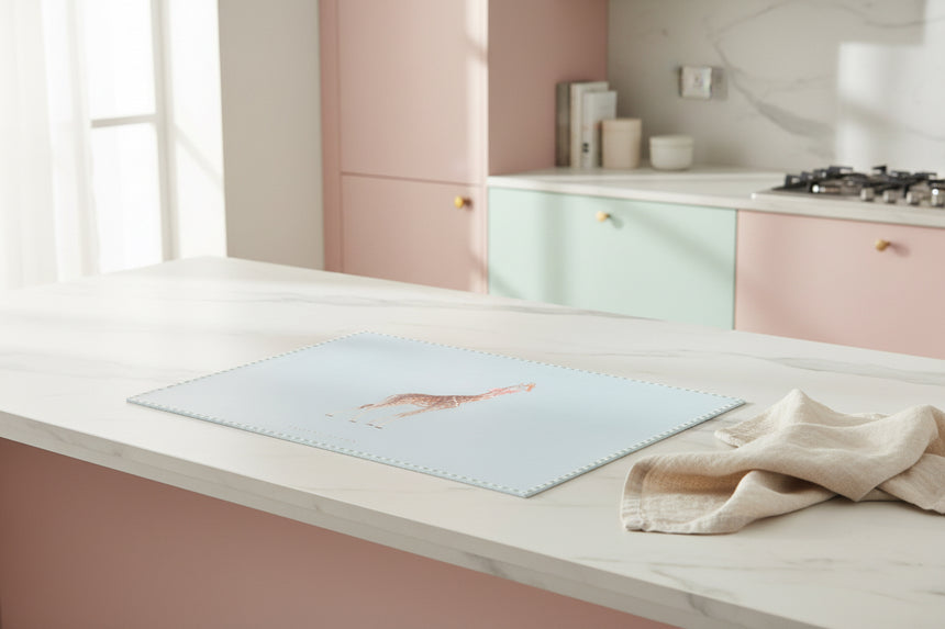 Light blue worktop saver with a giraffe  design on a white background