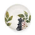 Round ceramic plate with leaf and berry design on a white background