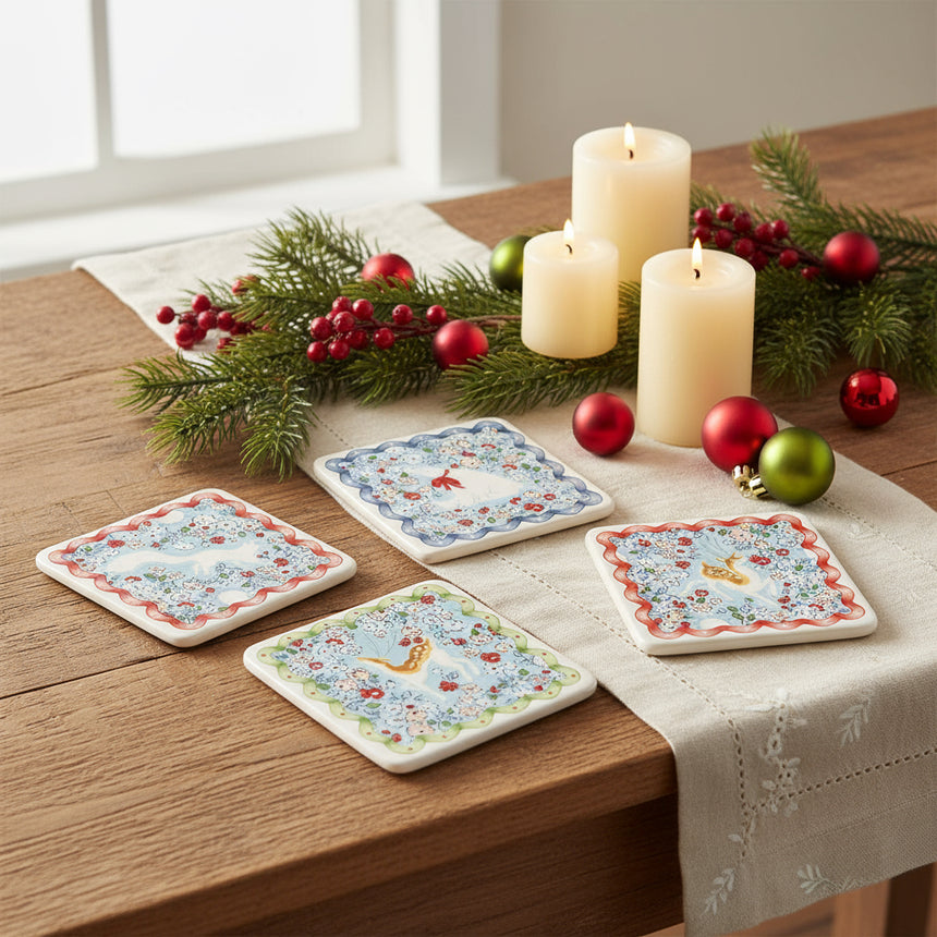 Set of four coasters  with floral and animal designs on a white background