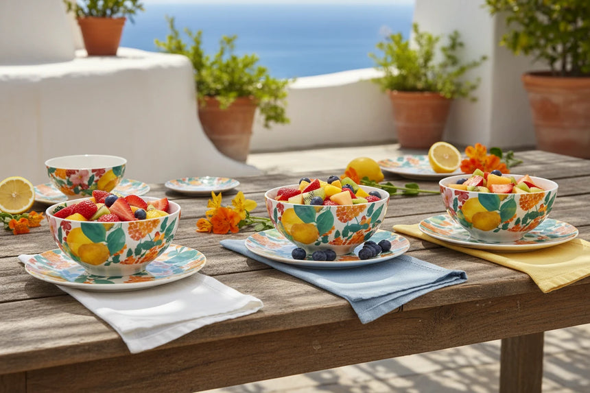 Three ceramic bowls with fruit pattern on a white background