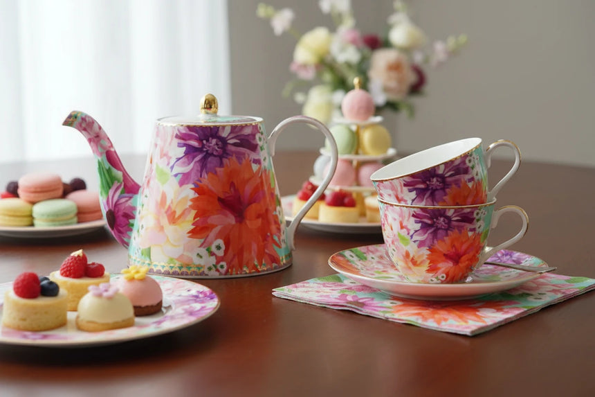Colorful floral teapot on a white background